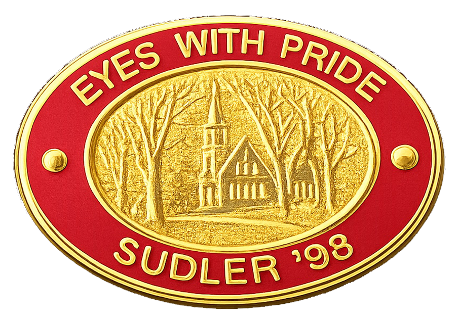 Pin worn on the 2001-2017 uniform. It reads "UMMB" with "energy, enthisuasm, excellence" around the outer band.