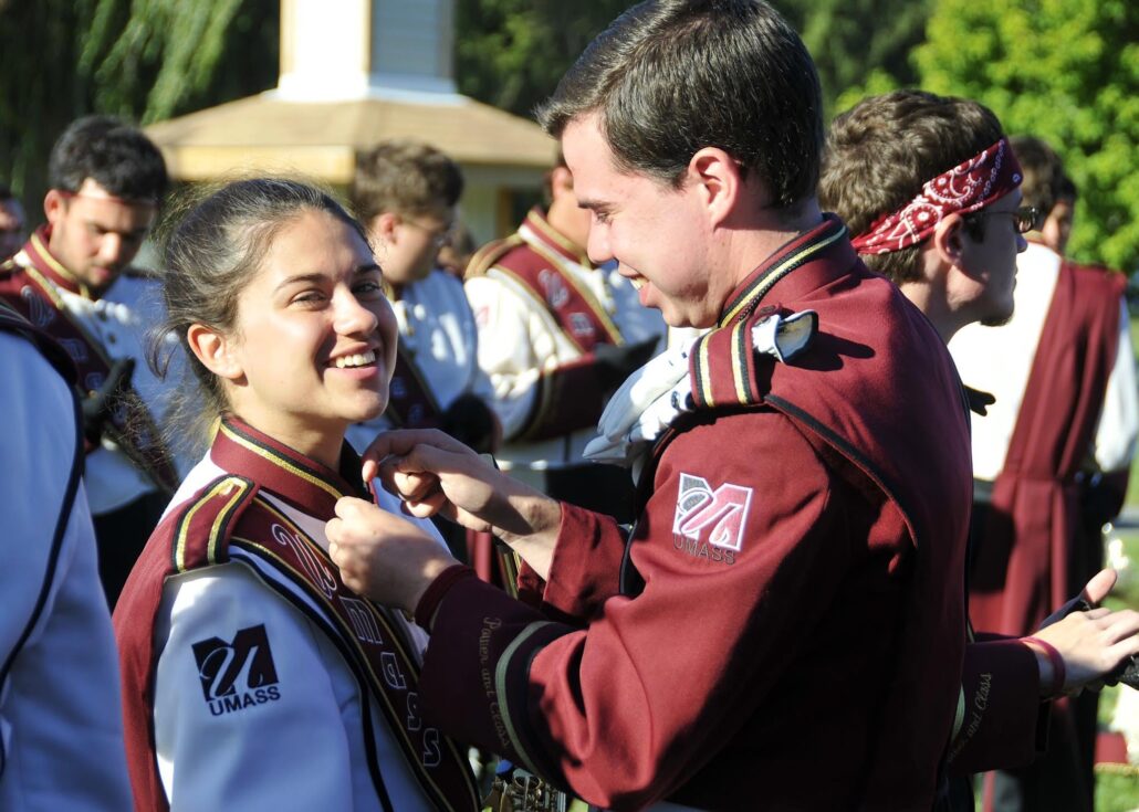 Drum major Mike Nicholson pins his sister Jackie before a show